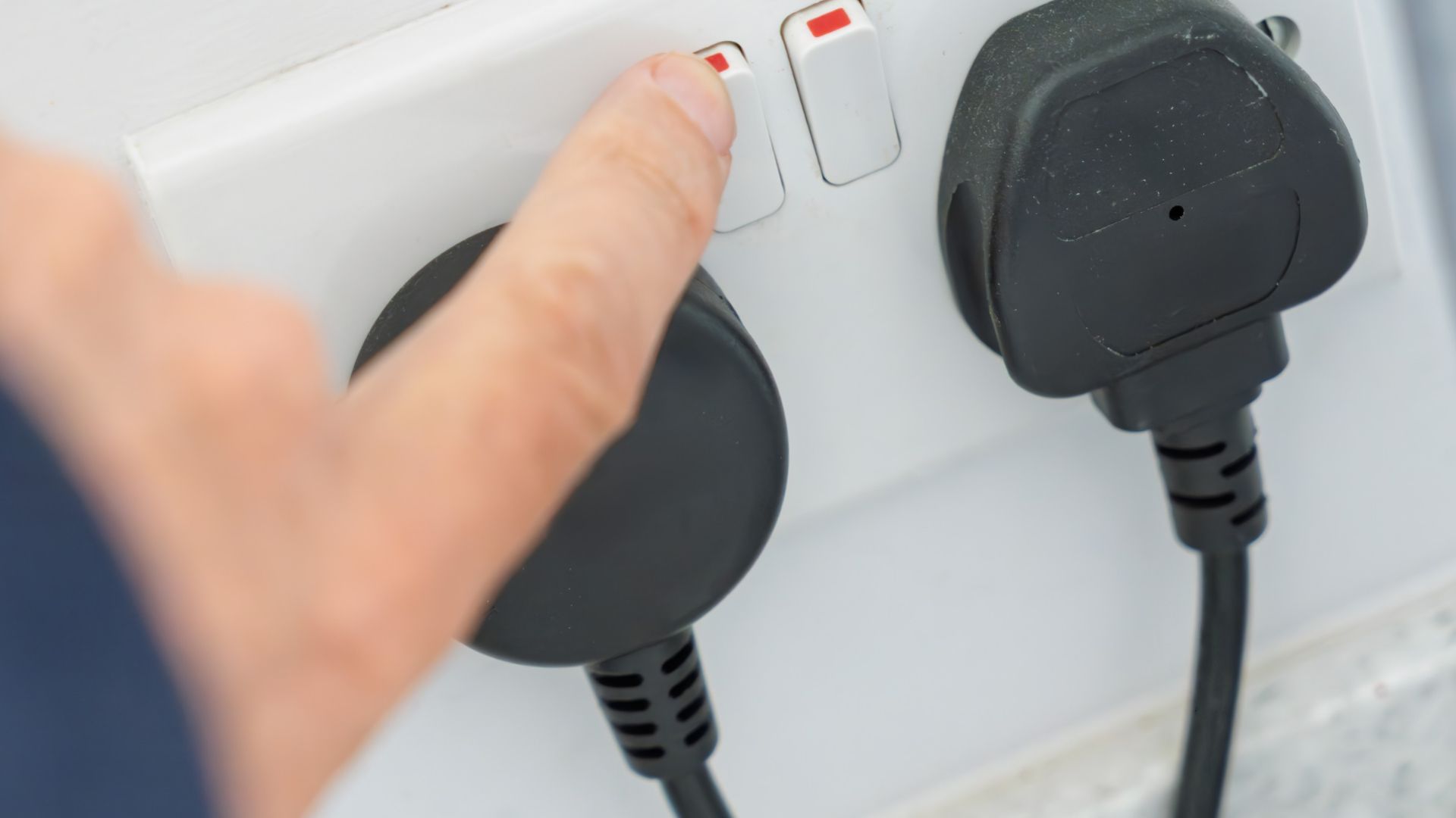 picture of woman turning on plugs at socket