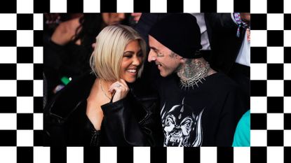 When is Kourtney Kardashian due? Pictured: Kourtney Kardashian and Travis Barker at an event smiling at each other on a checkerboard background