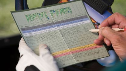 Golfer filling out scorecard