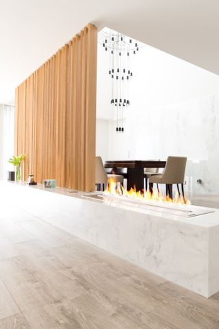 a freestanding fireplace in the middle of a room