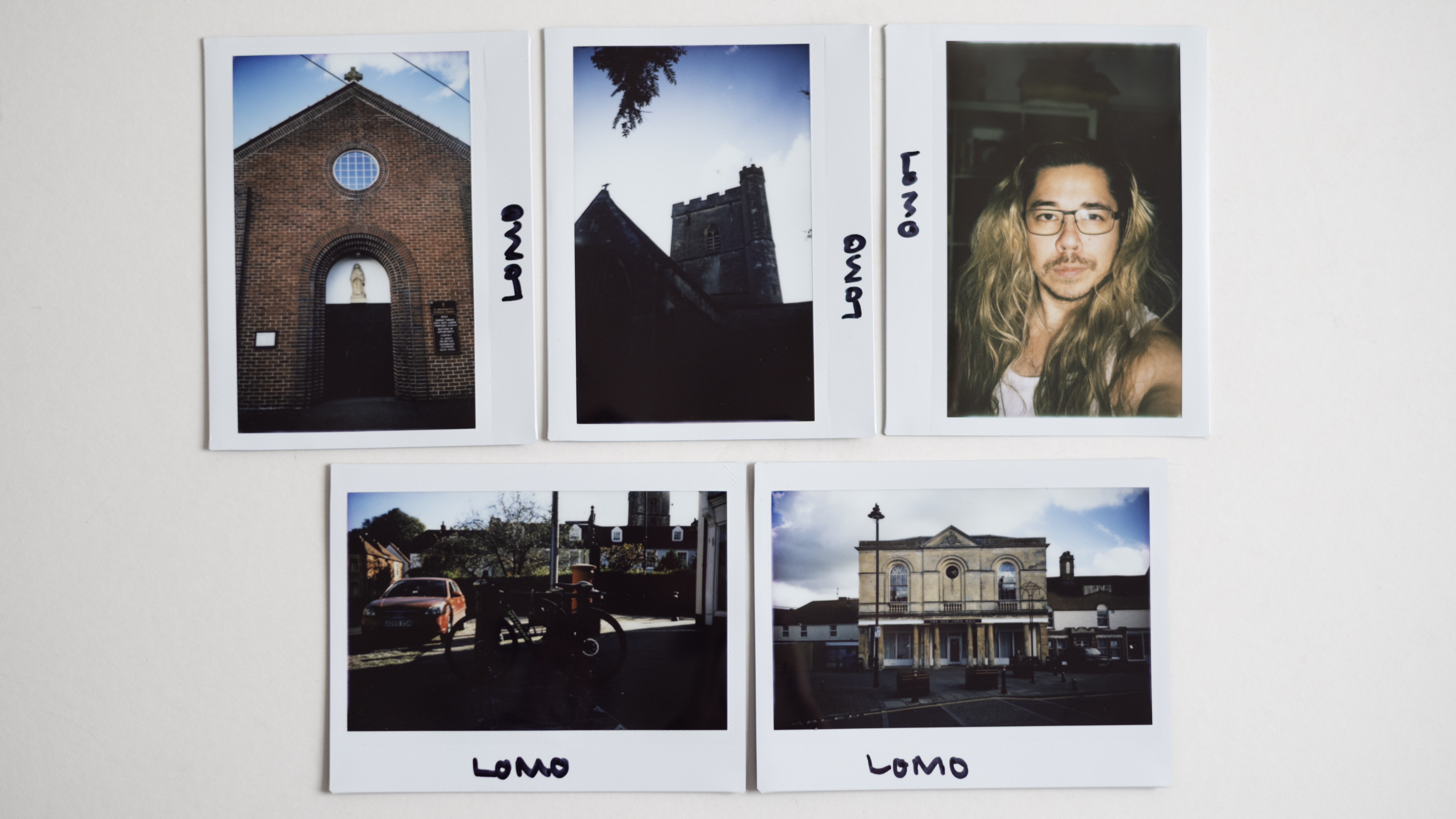 Sample images taken with the Lomo'Instant Wide Glass camera, sitting on a white surface