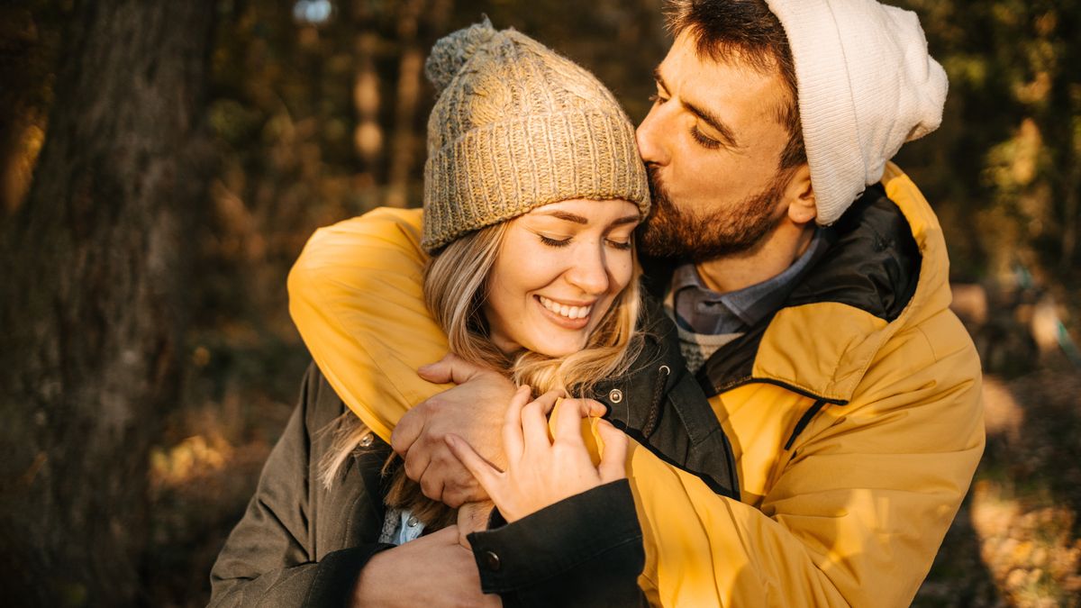 Man and woman kissing on hiking trail