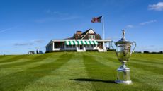 US Open trophy positioned on grass outside of Shinnecock Hill's clubhouse