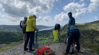 A group of climbers packing away their ropes