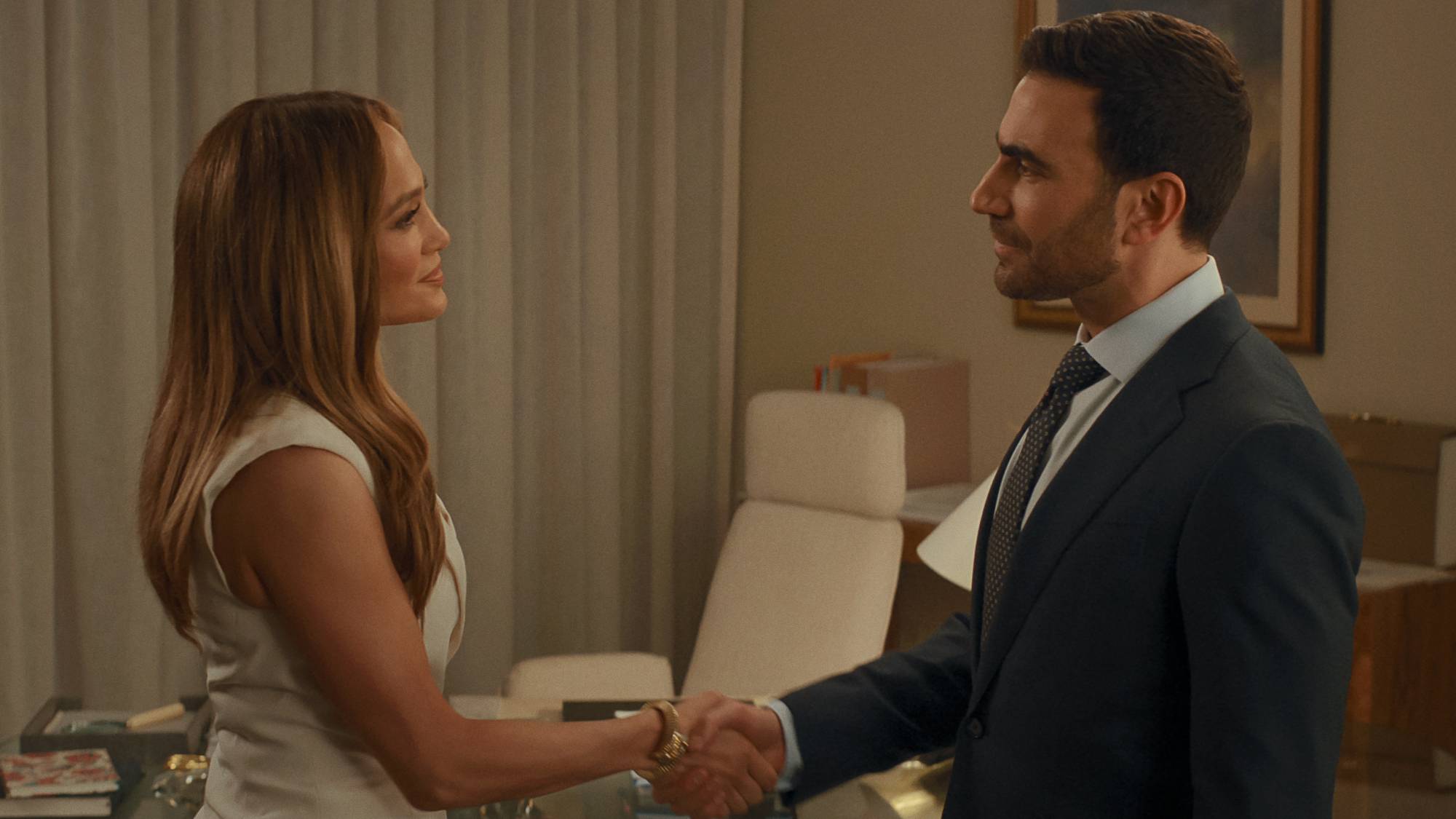 (L-R) Jennifer Lopez as Jackie Cruz and Brett Goldstein as Daniel Blanchflower in "Office Romance"