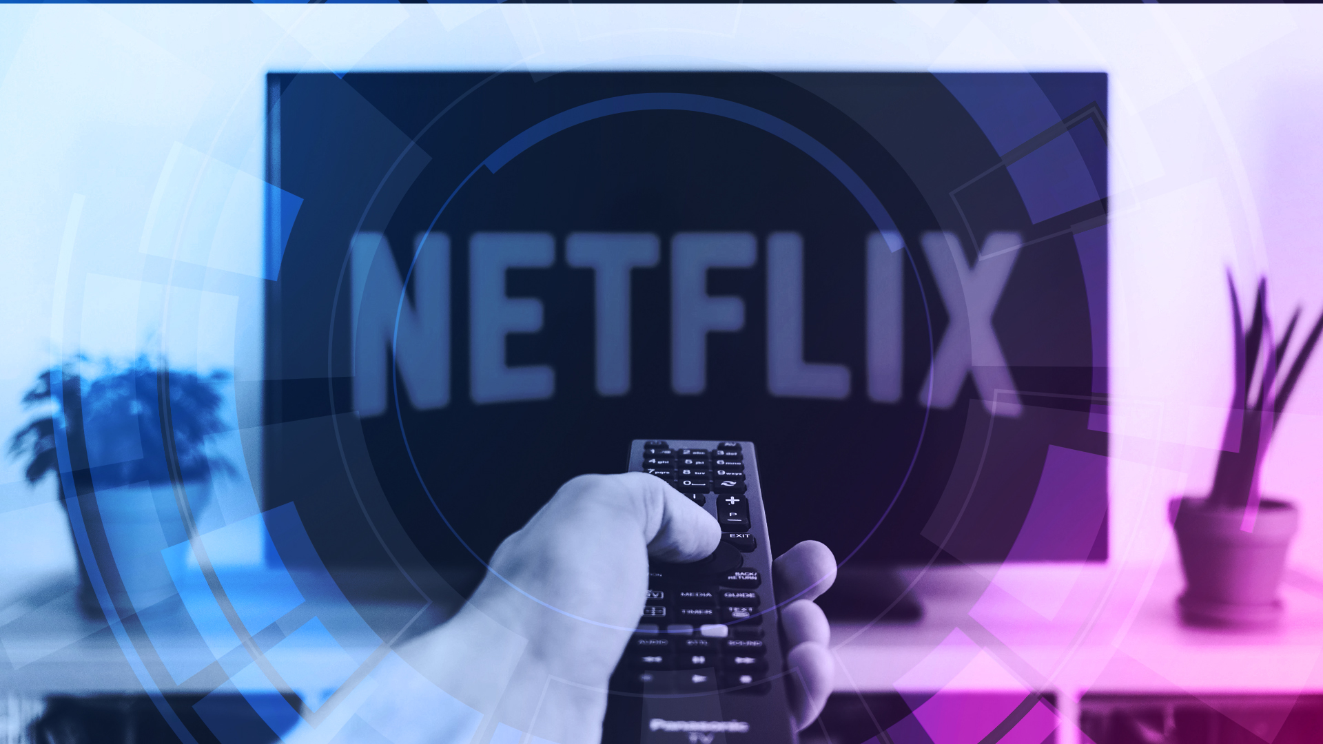 A hand holding a remote control in front a TV screen showing Netflix