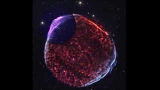 a blob-looking supernova with red and purple hues, set against a black background with stars
