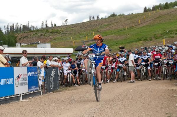 2009 short track national champion Adam Craig (Giant/Rabobank) gives a display of showmanship by riding a wheelie at his call-up to the start line.