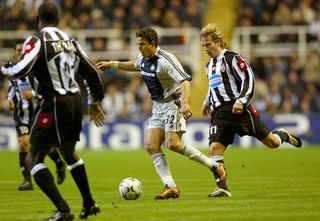 Newcastle's Laurent Robert (C) takes the ball past Juventus' Pavel Nedved (R) while Lilian Thuram (L) runs back during the Champions League Group E match at St. James's Park in Newcastle 23 October 2002.
