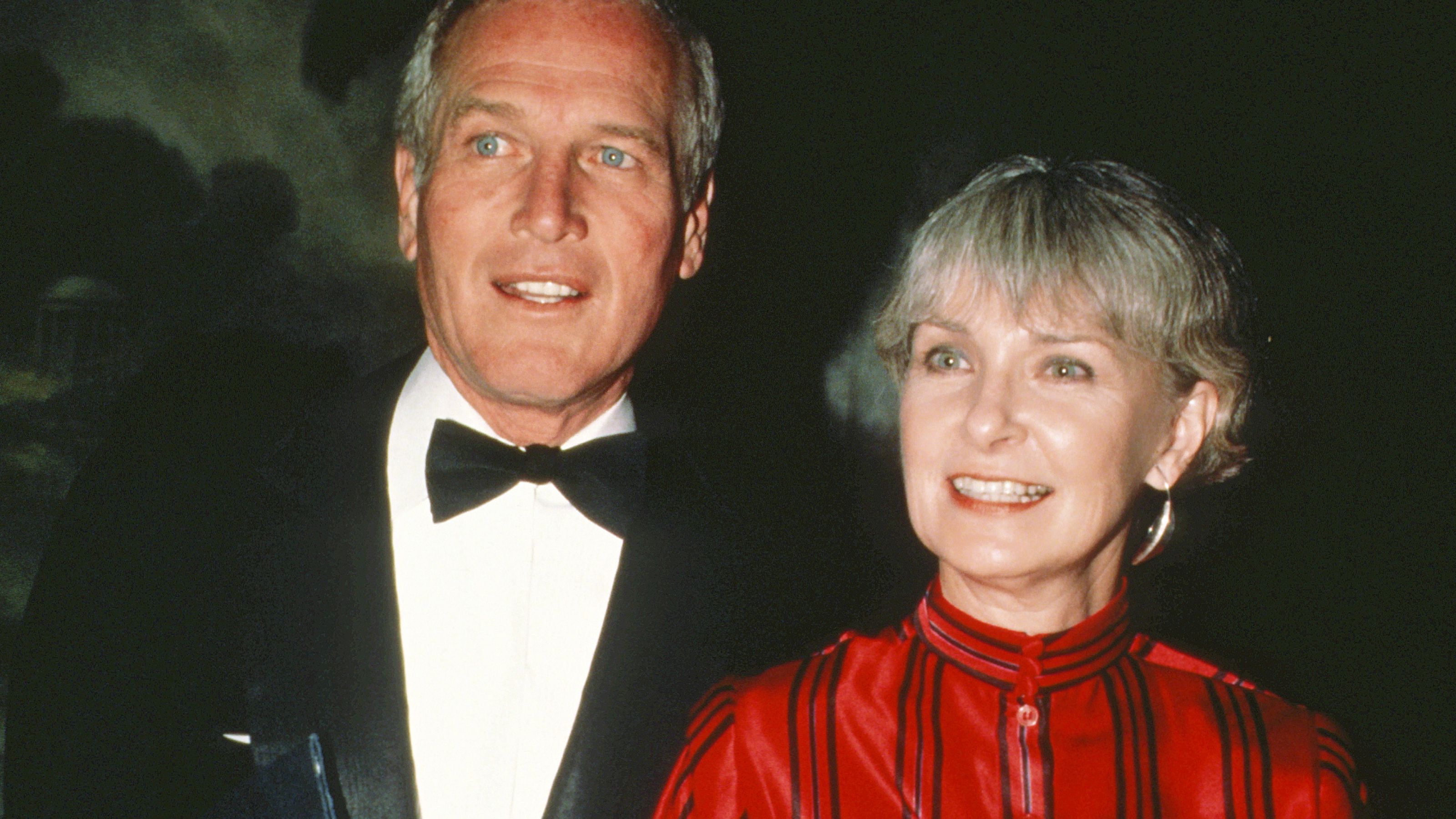 paul newman and joanne woodward on a black background