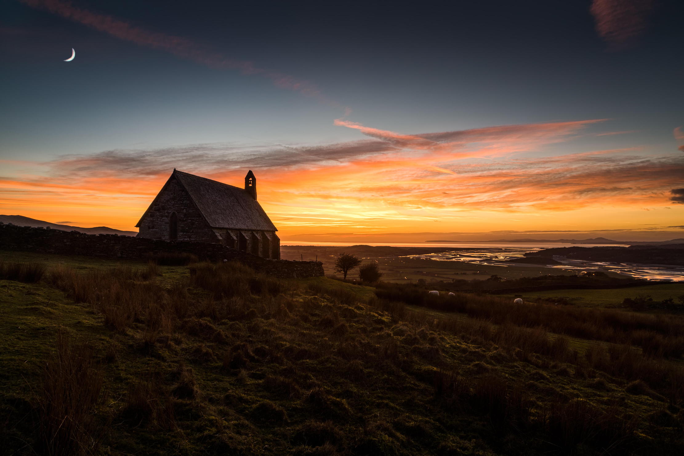 A church silhouetted at sunset