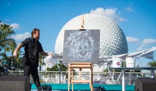 An Artist drawing Donald Duck in front of Spaceship Earth