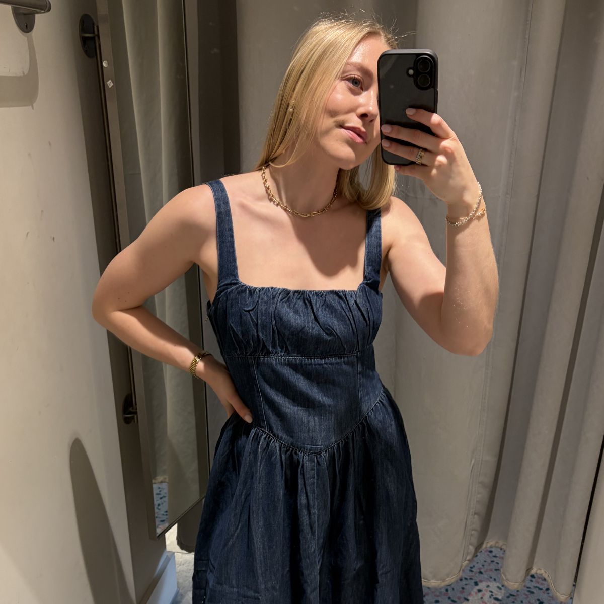 Woman wears blue denim midi dress