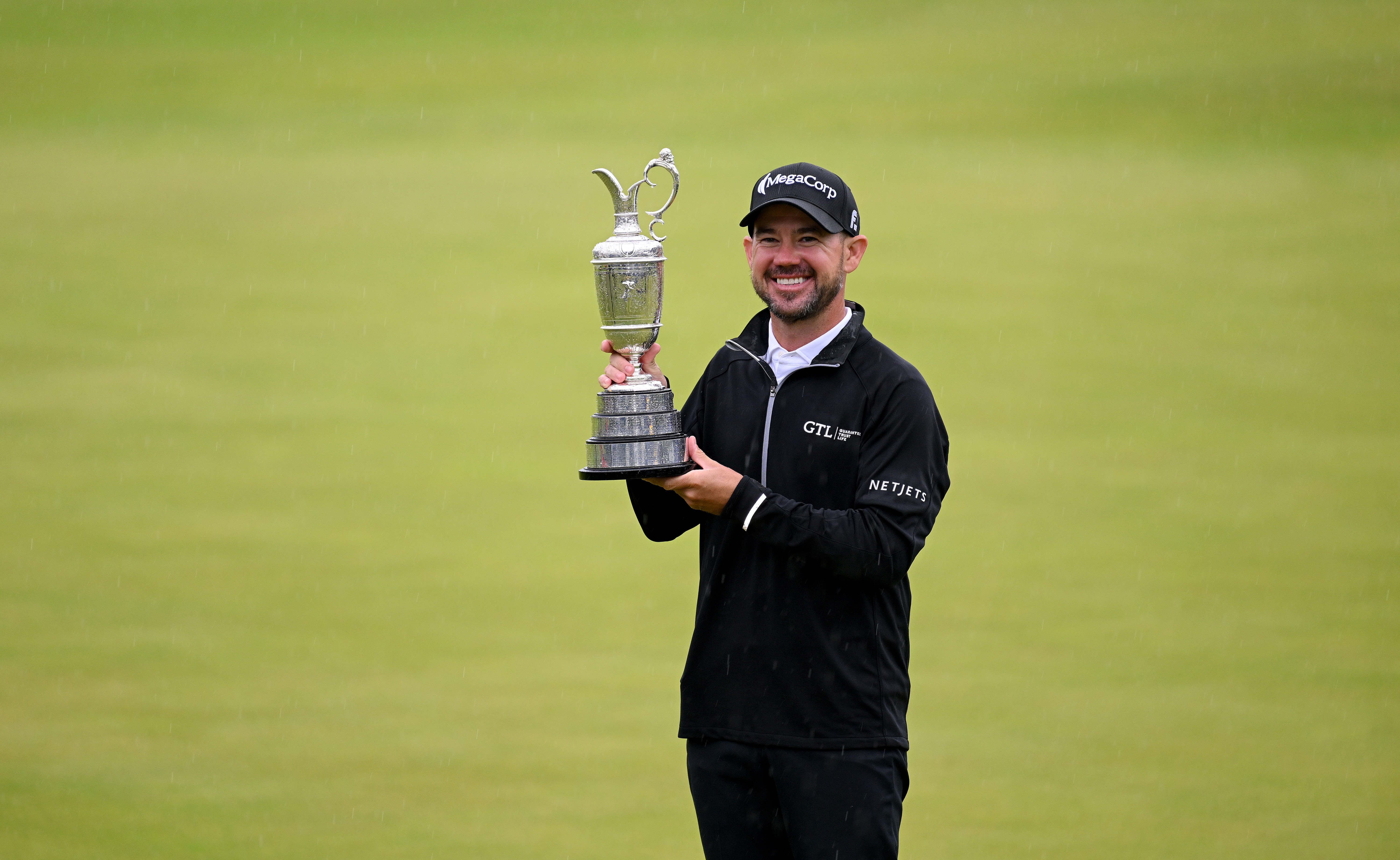 Brian Harman poses for a photograph with the Claret Jug on the 18th green as he celebrates winning The 151st Open.