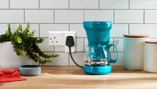 Amazon smart plug connected to a coffee maker in a kitchen