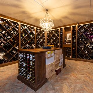 wine cellar with bar table and chandelier