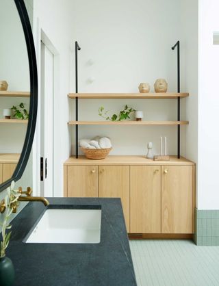 a bathroom with green tiles and white walls