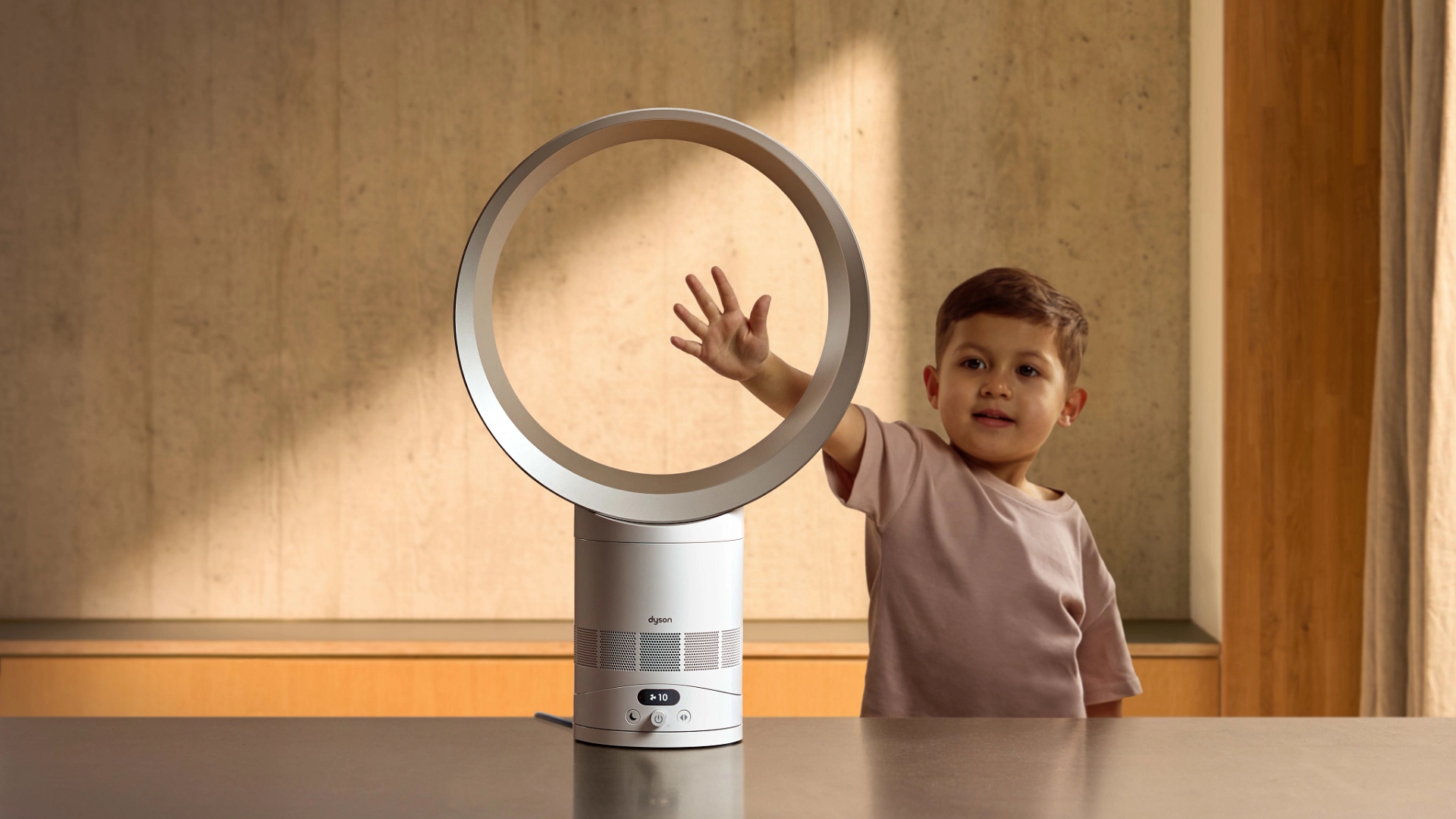 A child putting his hand by the Dyson Cool CF1 bladeless fan