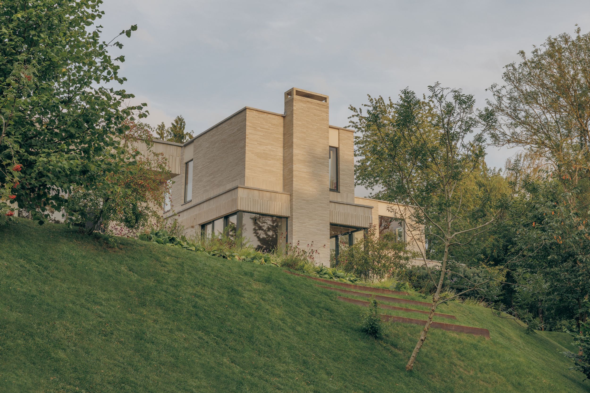 A serene riverside home in the British countryside unites minimalism and nature
