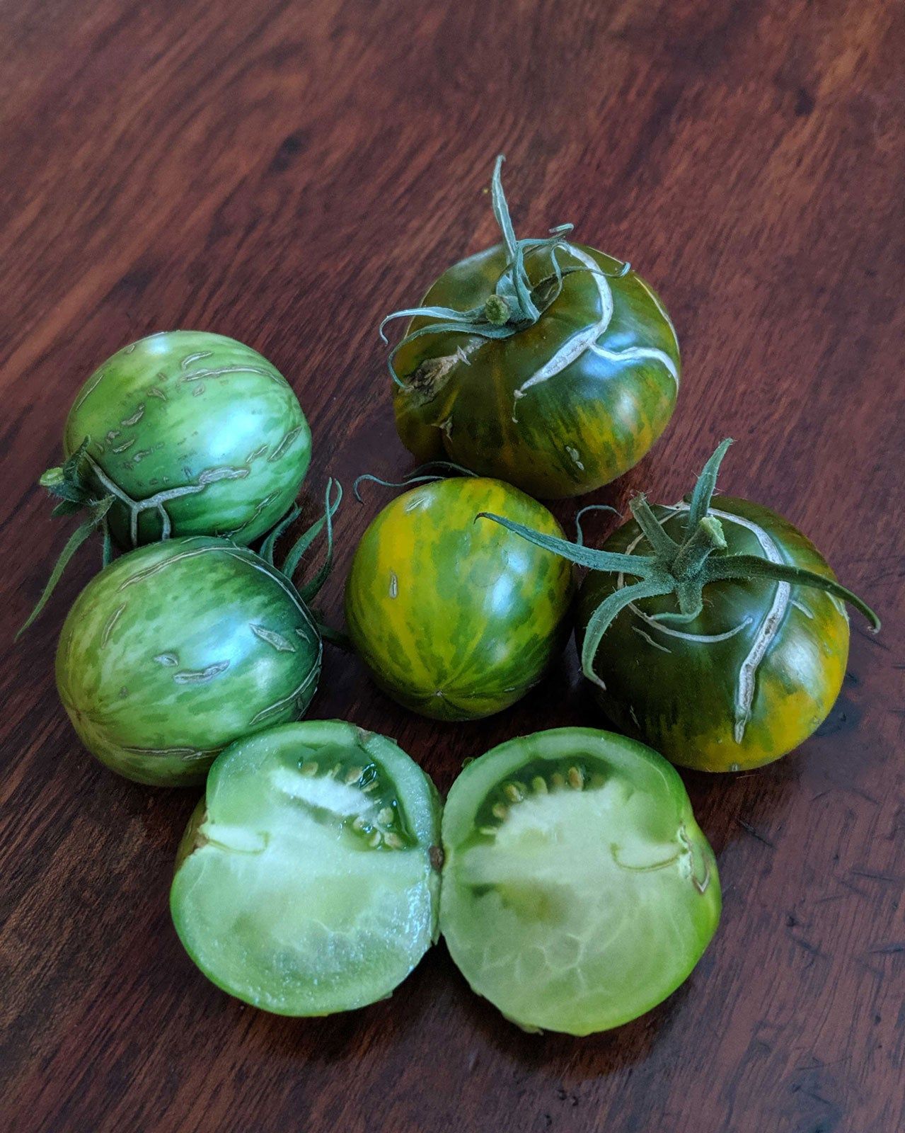 Whole And Sliced Green Moldovan Tomatoes