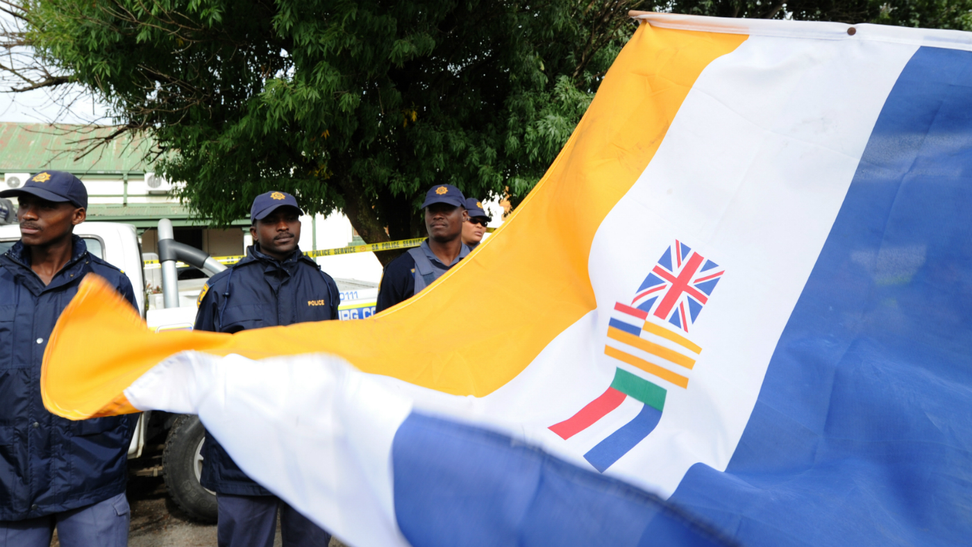 White South African man holds up a flag for the Afrikaner