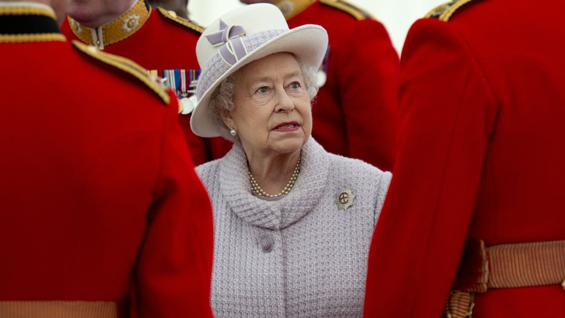 Queen Elizabeth II between her guards