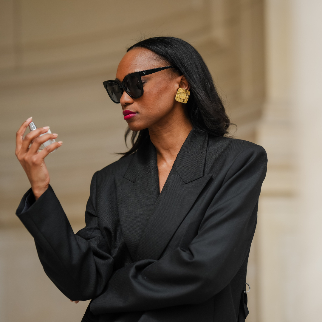 How to tell if perfume has expired Emilie Joseph wears sunglasses, golden earrings, red lipstick, a black oversize blazer jacket, uses a bottle of perfume during a street style fashion photo session, on May 12, 2024 in Paris, France
