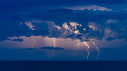 A lightning storm over a dark sea.