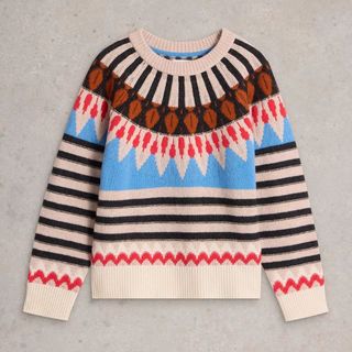 A cut out of a fairisle jumper from the White Stuff with stripes and blue and red and navy decoration shot against a speckly grey background