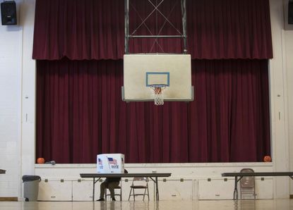 A voter casts his ballot.