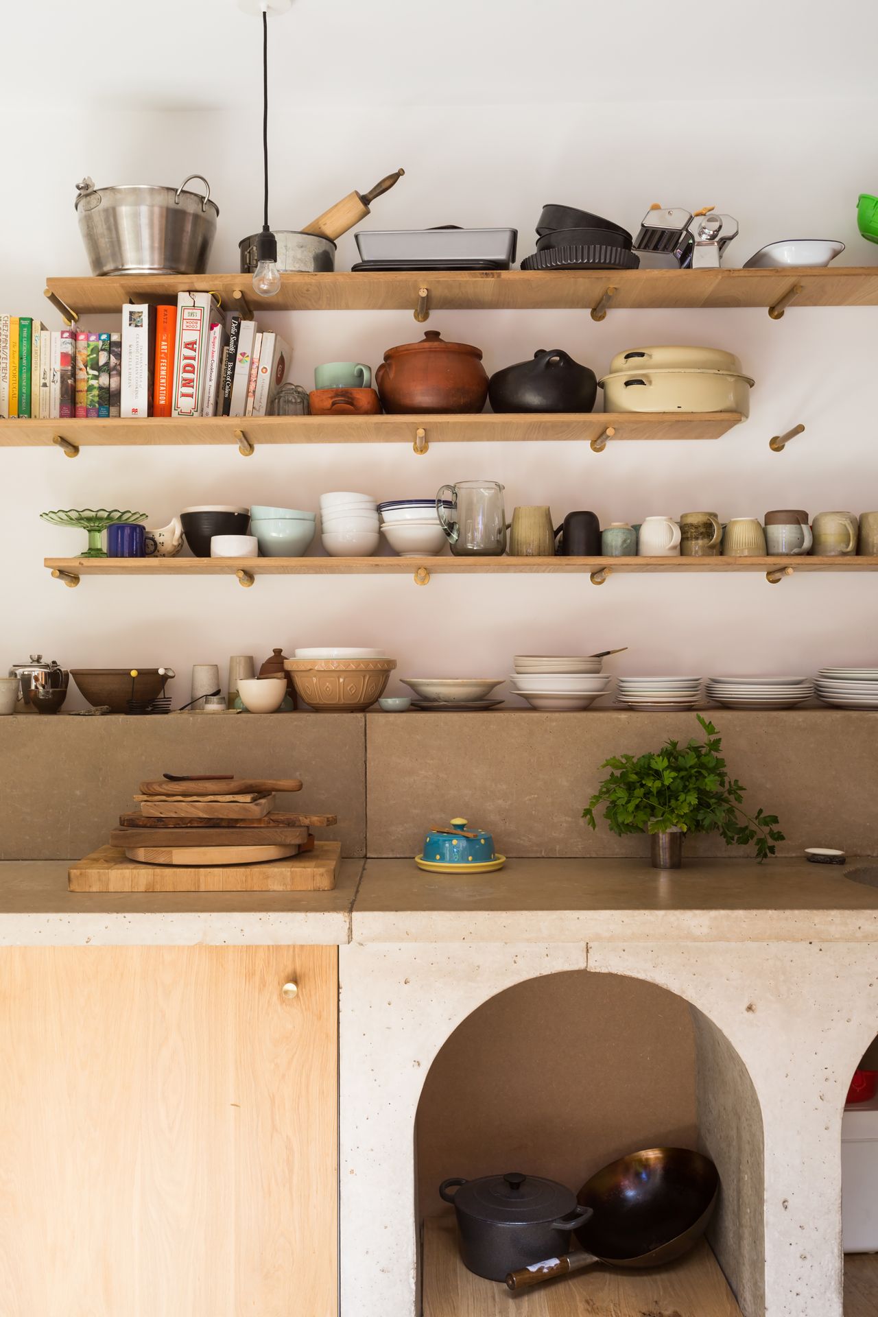 open kitchen shelving with concrete worktop