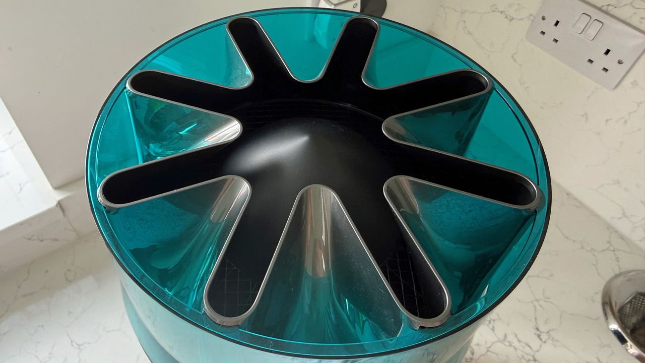 Top view of the Dyson HushJet showing the turbine-inspired air outlet design with curved black vents inside blue housing