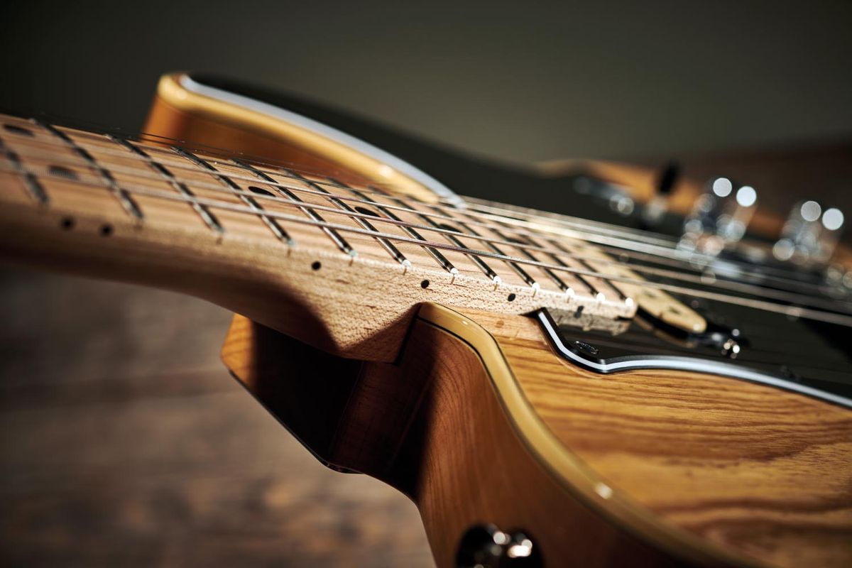The fretboard is the facing of the neck, with no extra wood laid on top.