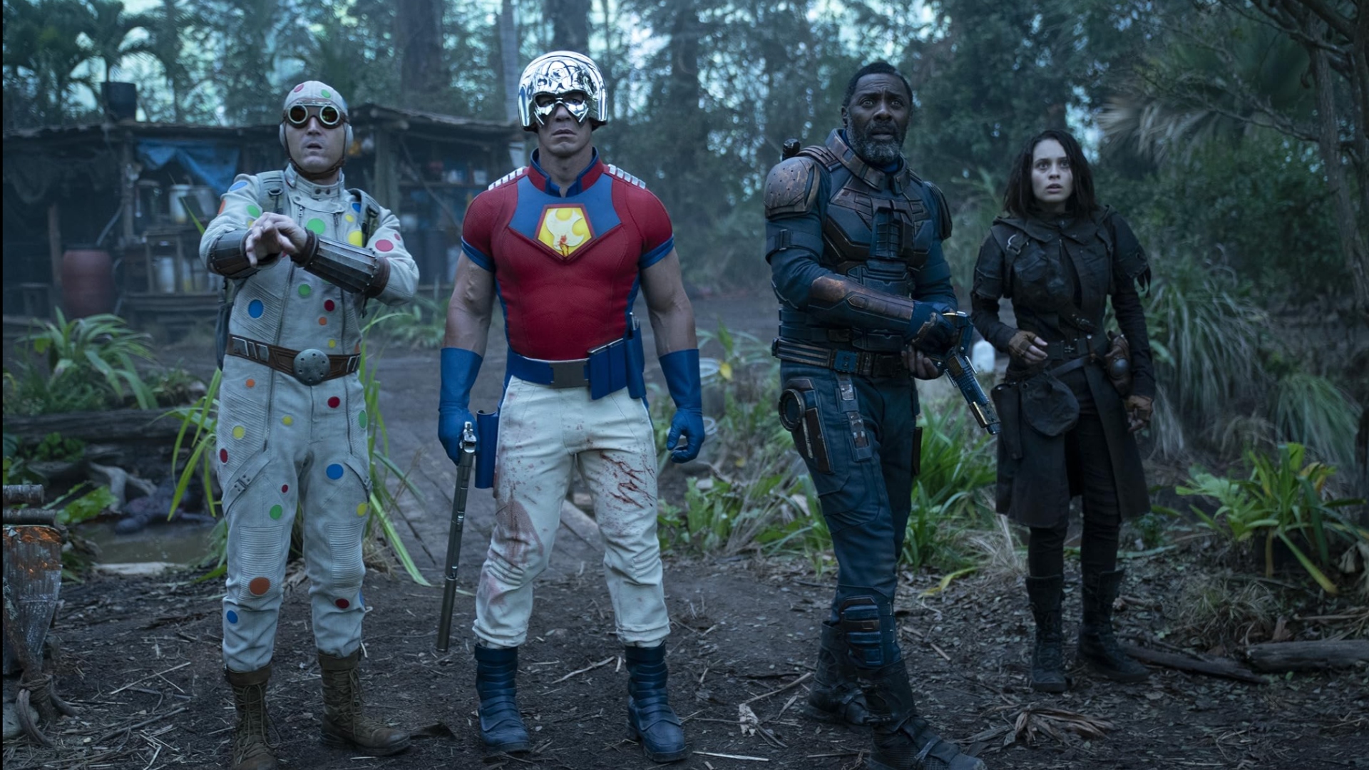 David Dastmalchian as Polka-Dot Man, John Cena as Peacemaker, Idris Elba as Bloodsport, and Daniela Melchior as Ratcatcher 2 in The Suicide Squad.