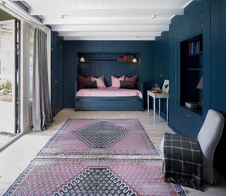 Blue and pink spare bedroom in a summer house
