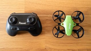 Potensic A20 Mini Drone and controller side by side on a wooden table