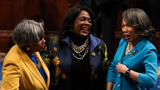 Representative Brenda Lawrence (D-Michigan), Representative Terri Sewell (D-Alabama), and Representative Lisa Blunt Rochester (D-Delaware) dressed in various shades of yellow and blue.