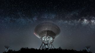 A radio telescope with the Milky Way in the background