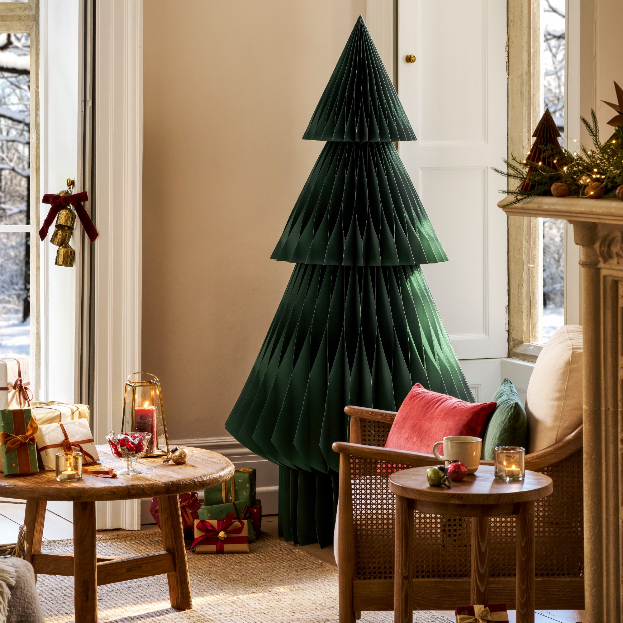 A green honecomb paper Christmas tree by Garden trading in a living room decorated for the holiday