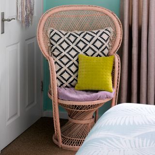bedroom with wicker peacock chair and carpet flooring