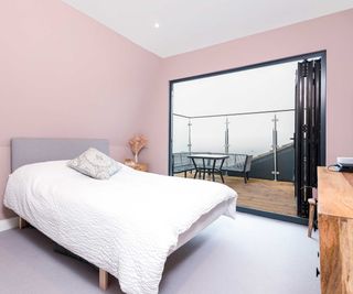 pink loft conversion bedroom with balcony