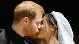 Prince Harry and Meghan Markle kiss on the steps of St George's Chapel in Windsor Castle after their wedding in St George's Chapel at Windsor Castle on May 19, 2018 in Windsor, England. (Photo by Ben Birchall - WPA Pool/Getty Images)