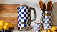 Blue and white check print electric kettle next to matching jug and utensil holder