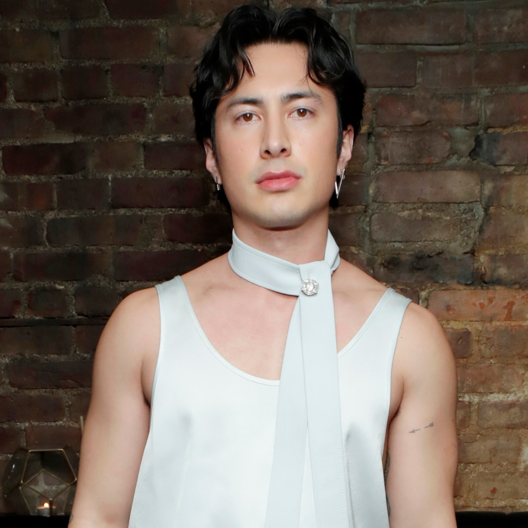 Hudson Williams attended a New York Fashion Week party in an all white silk look and a matching tie