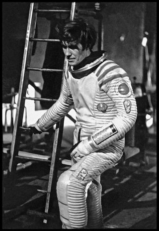 Bill Weston recovering from oxygen deprivation at the base of the launch tower during intense filming of spacewalk sequences.
