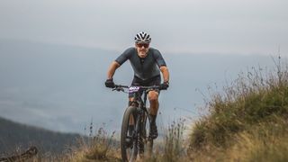 Grinduro racer riding up a hill