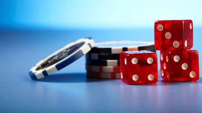 poker chips with dice on table to represent gambling