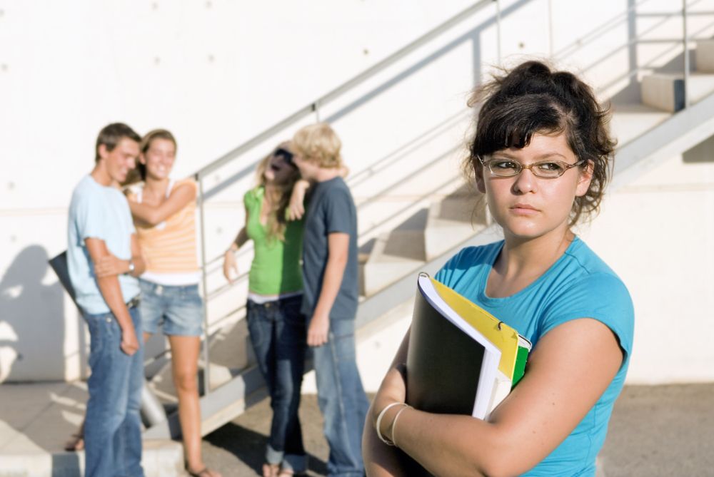 shy teen girl next to popular students