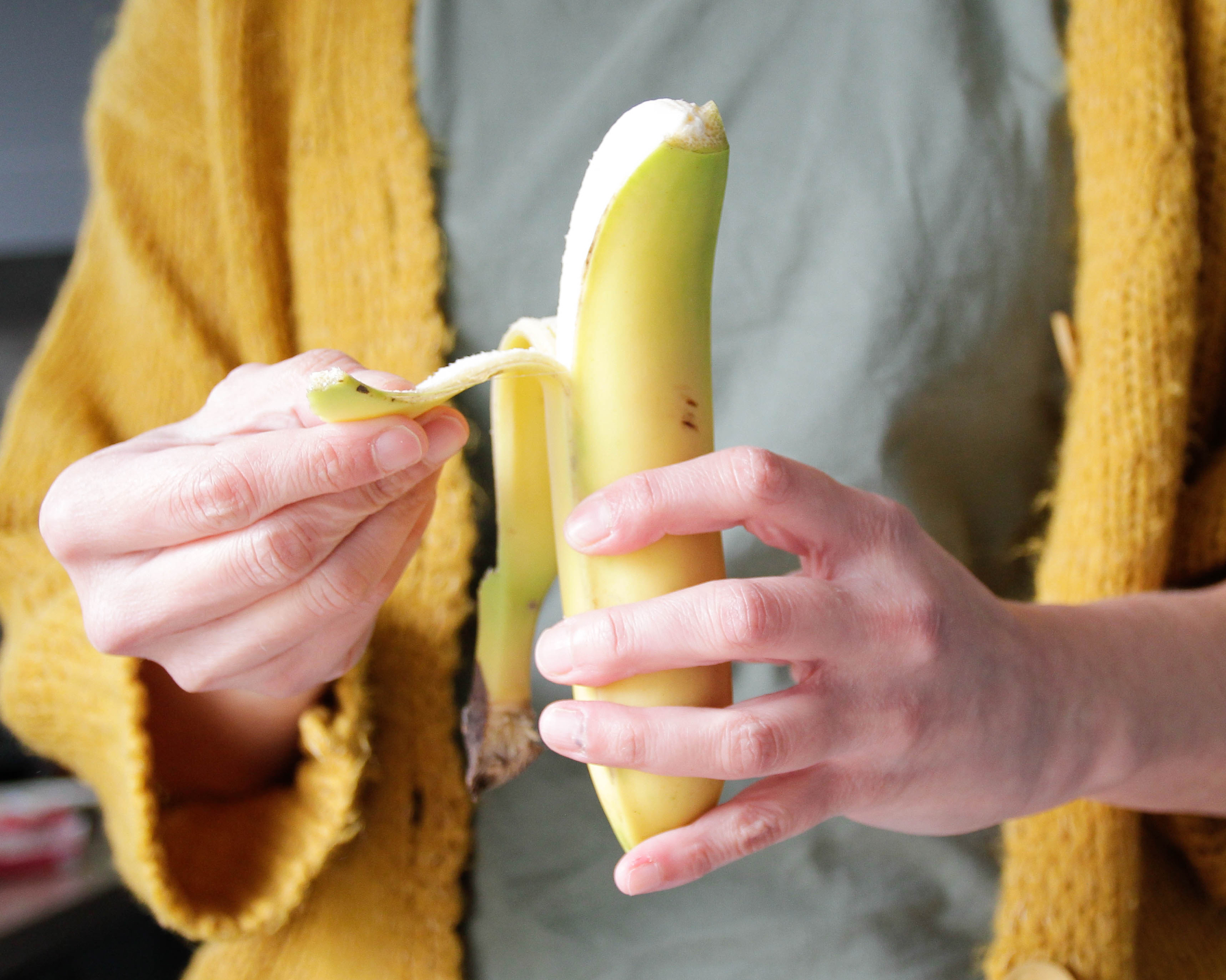 Woman peeling a banana