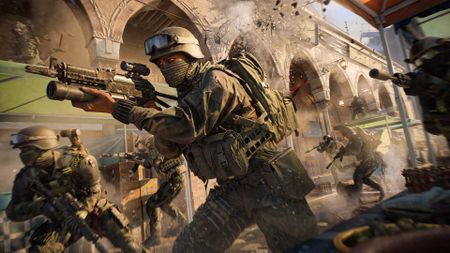Battlefield 6: A group of Pax Armada soldiers with guns at the ready, running through a bazaar. A part of the wall is exploding in the background.